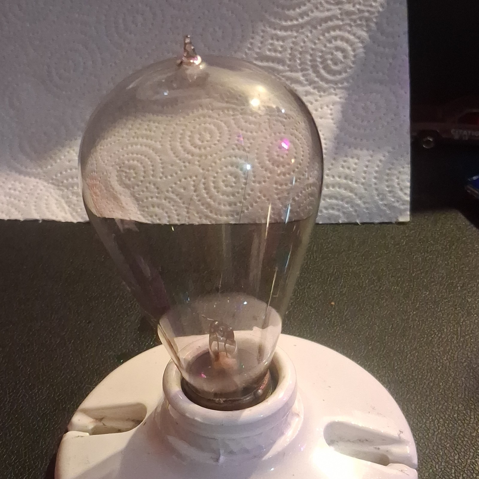 vintage 1890's hand blown working light bulb. on a vintage porcelain socket.