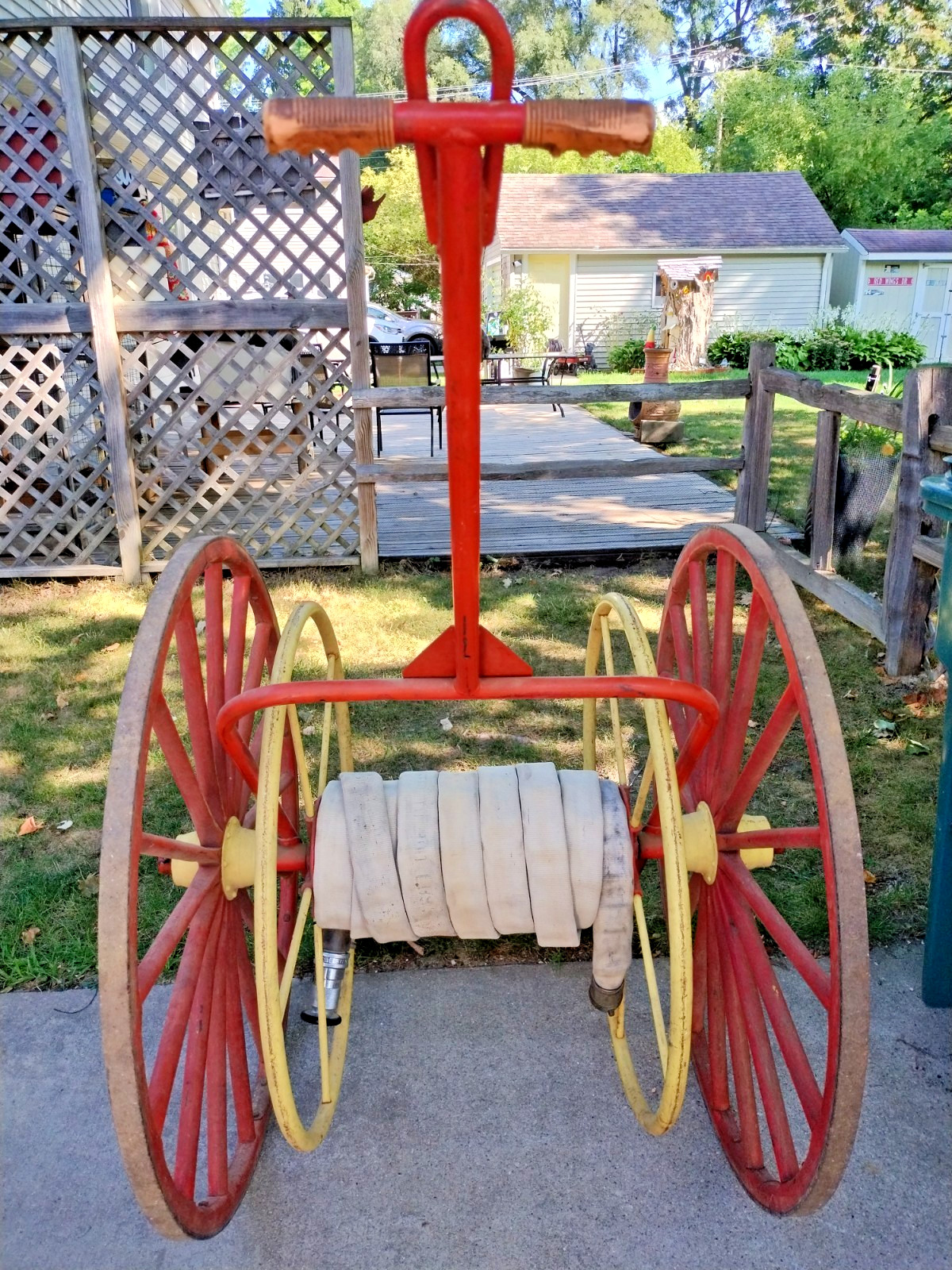 Antique Hand Drawn Fire Hose Transporter with Hose and nozzle.