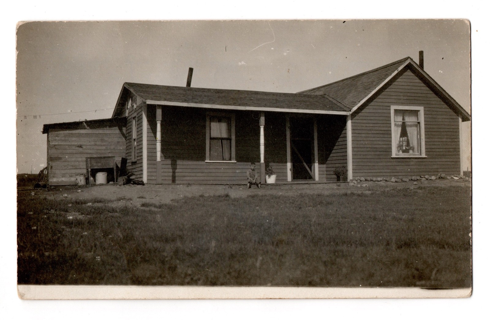 Boy Sitting On Porch Early Plain Jane Wood Frame House Photo Postcard RPPC