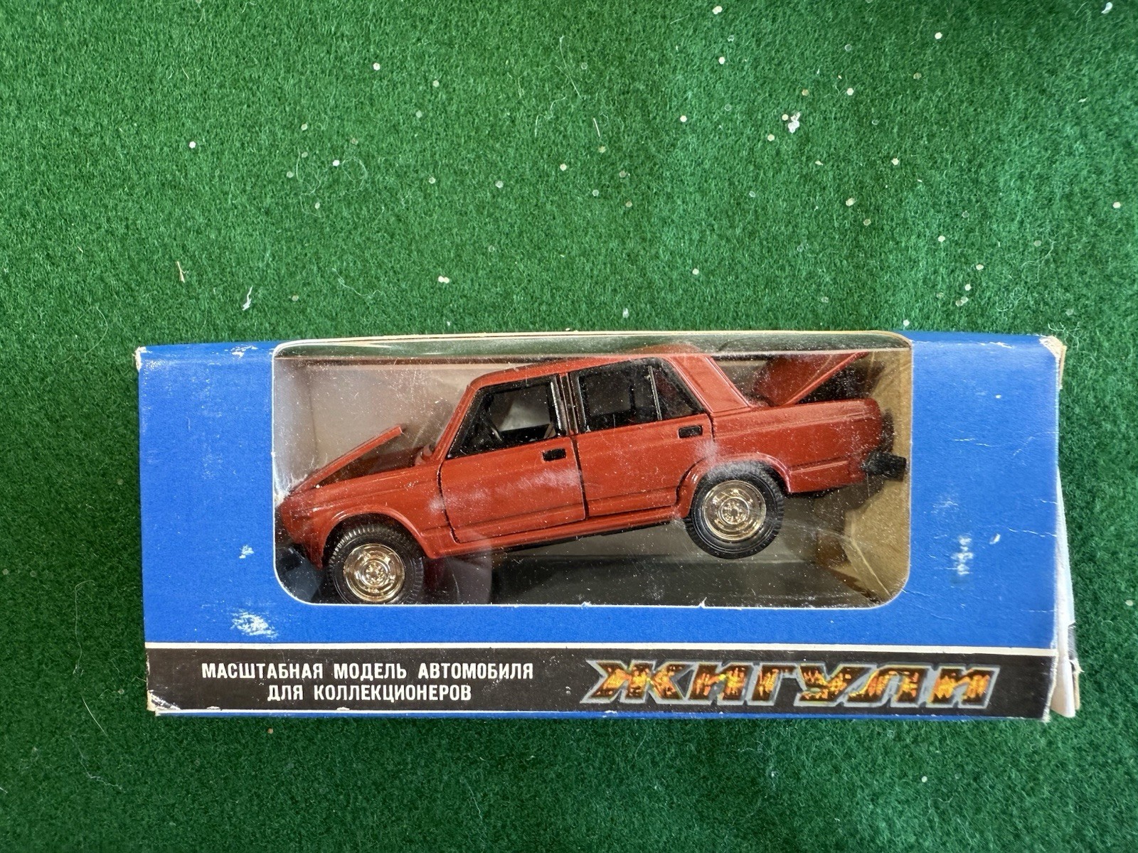 vintage 1:43 scale model of a Soviet-era red Lada (VAZ-2105 / Zhiguli)