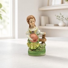 Vintage Porcelain Victorian-style Girl Figure with a Hat and Rustic Fence picture